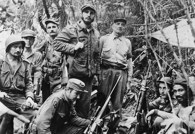 With Fidel Castro (standing) and others on the Sierra Maestra